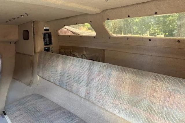 Slide: The Image of Interior of 1991 Corsair F-27 #227 sailboat with cushioned seating and windows. - 8