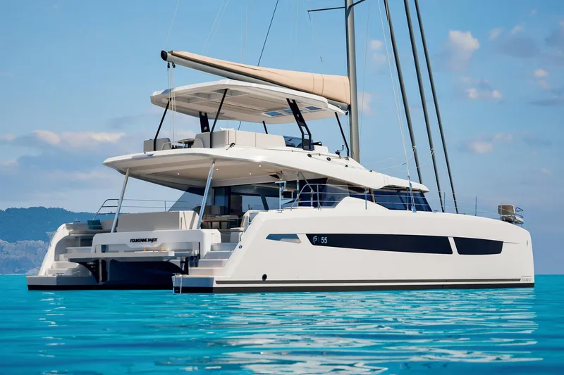Slide: The Image of 2026 Fountaine Pajot 55 catamaran sailing on clear blue waters. - 0