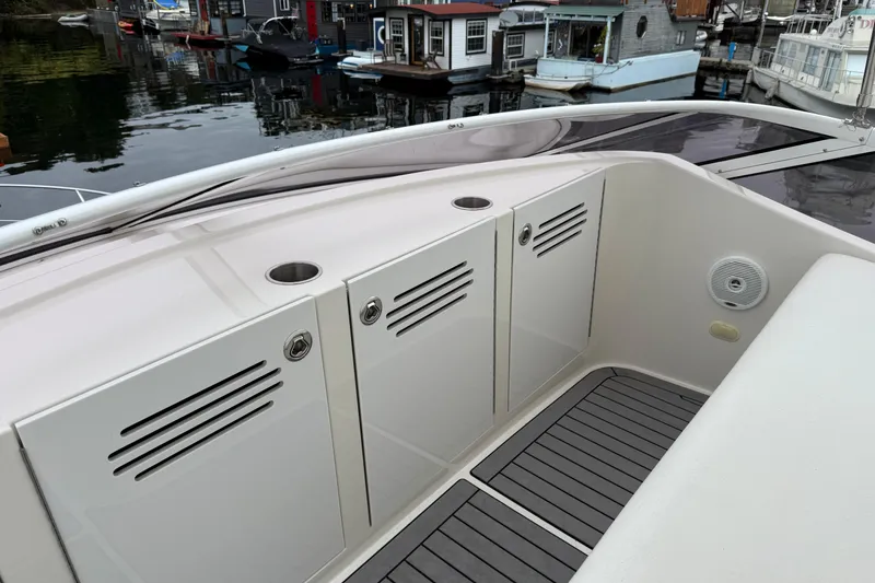 Slide: The Image of 2007 Carver 35 Super Sport yacht deck with storage compartments and waterfront view. - 10