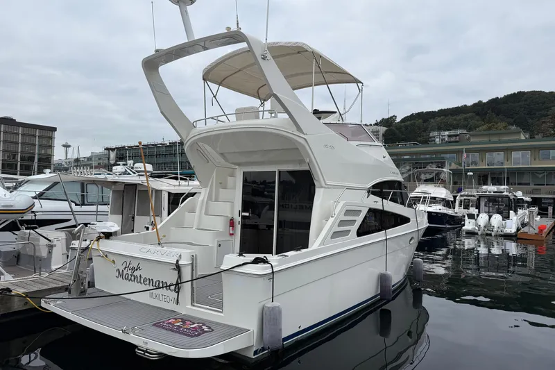 Slide: The Image of 2007 Carver 35 Super Sport yacht docked at marina, overcast sky, waterfront buildings. - 25