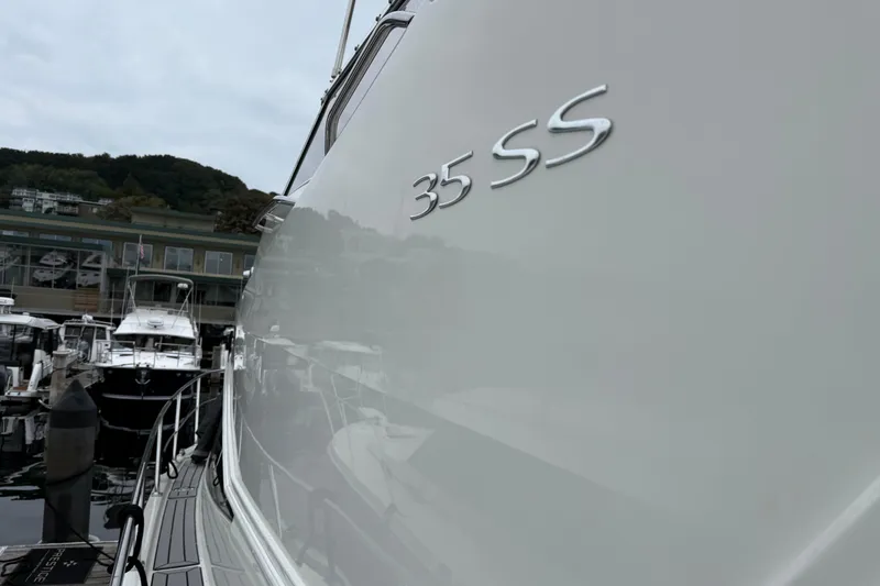 Slide: The Image of 2007 Carver 35 Super Sport yacht docked at marina, side view with "35 SS" emblem. - 3