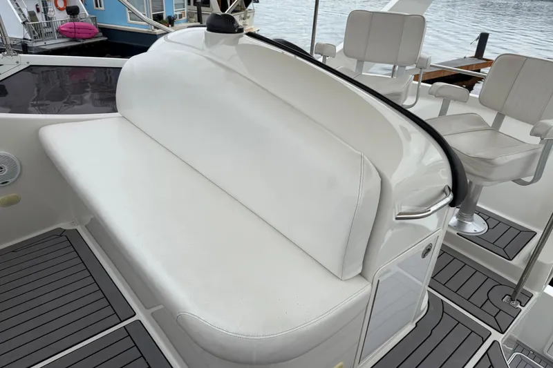 Slide: The Image of 2007 Carver 35 Super Sport boat interior with white seating and modern design. - 9