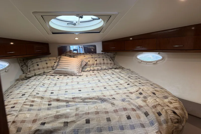 Slide: The Image of Luxurious cabin interior of 2007 Carver 35 Super Sport yacht with cozy bedding. - 16