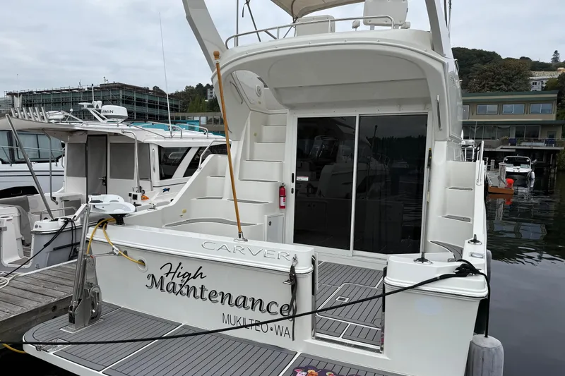 Slide: The Image of 2007 Carver 35 Super Sport yacht docked, featuring spacious deck and sleek design. - 2