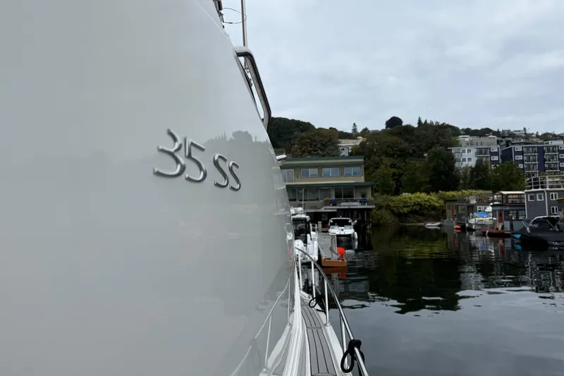 Slide: The Image of 2007 Carver 35 Super Sport yacht docked in a scenic marina setting. - 4