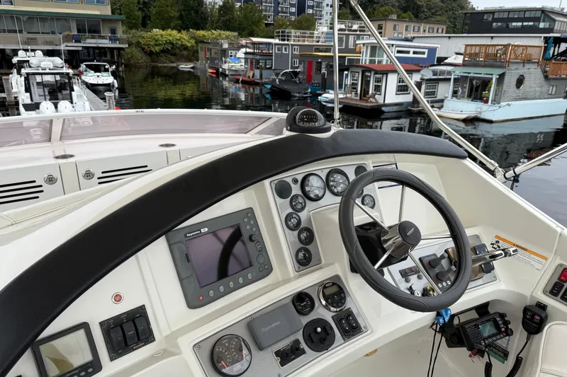 Slide: The Image of Helm of 2007 Carver 35 Super Sport yacht with navigation instruments and steering wheel. - 6