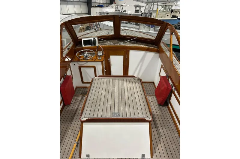 Slide: The Image of 1959 Forest E Johnson Prowler boat interior with wooden deck and steering wheel. - 5