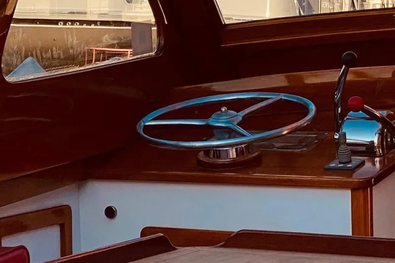 Slide: The Image of 1959 Forest E Johnson Prowler boat interior with steering wheel and controls. - 6