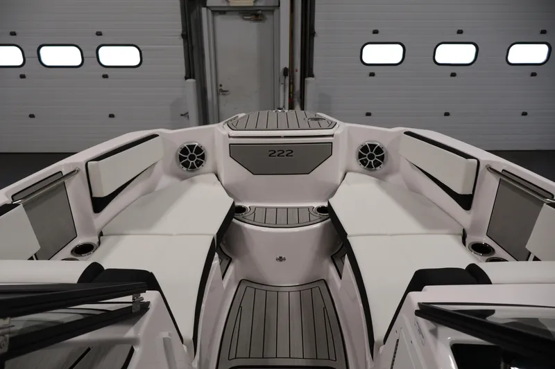 Slide: The Image of 2026 Yamaha Boats 222S interior with sleek seating and modern design in a garage setting. - 10