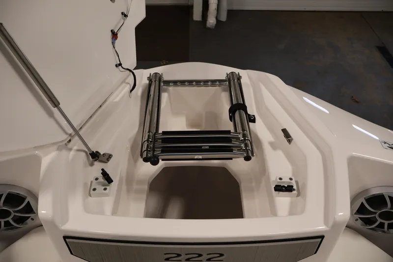 Slide: The Image of 2026 Yamaha Boats 222S bow storage with ladder and speaker detail. - 11