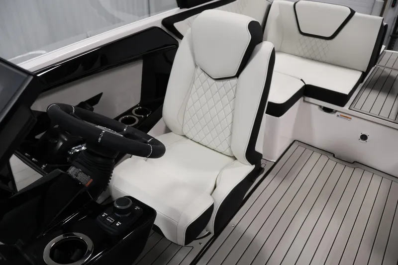Slide: The Image of 2026 Yamaha Boats 222S interior with white and black seating, modern steering, and sleek design. - 24
