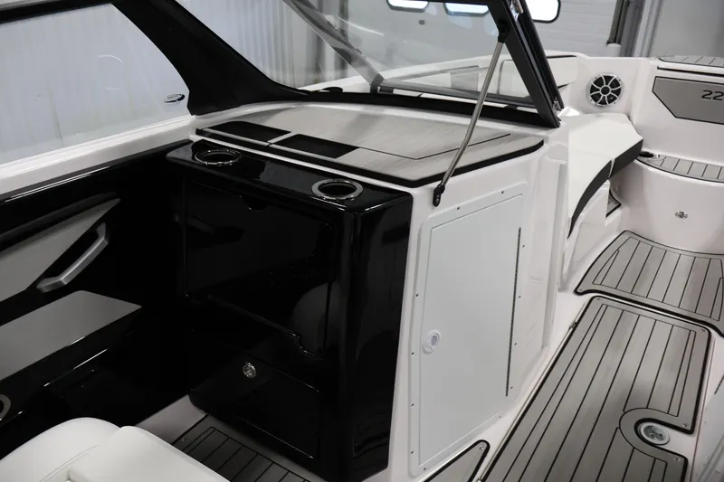 Slide: The Image of 2026 Yamaha Boats 222S interior with sleek black and white design, featuring cup holders. - 26