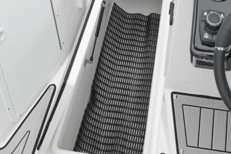 Slide: The Image of 2026 Yamaha Boats 222S in showroom, sleek design, light blue hull, on trailer. - 7