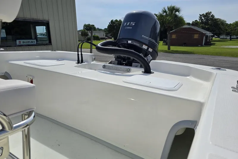 Slide: The Image of 2025 Sundance B20CCR boat with Yamaha 115 engine, parked outdoors. - 3