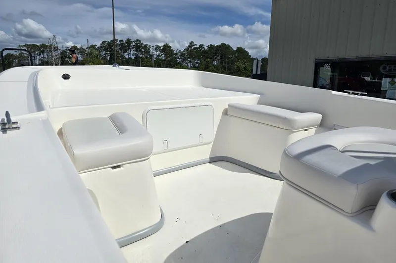 Slide: The Image of 2025 Sundance B20CCR boat interior with white seating and storage compartments. - 7