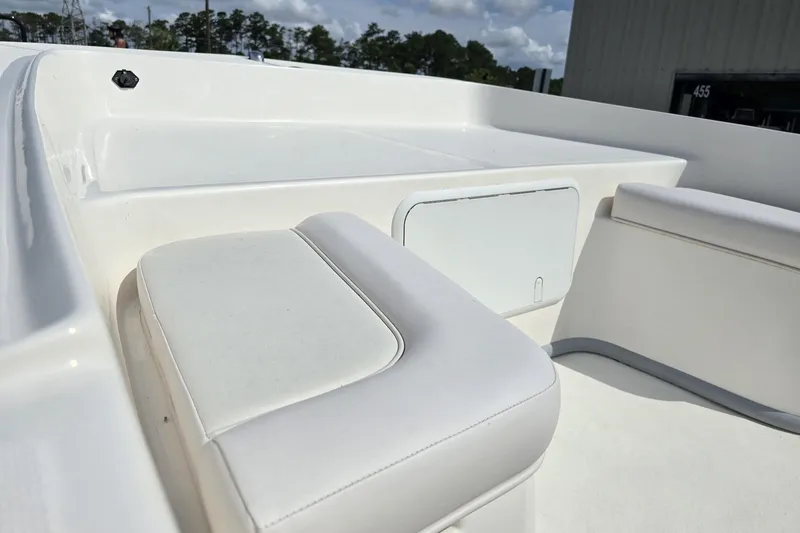 Slide: The Image of 2025 Sundance B20CCR boat interior with white seating and storage compartment. - 8