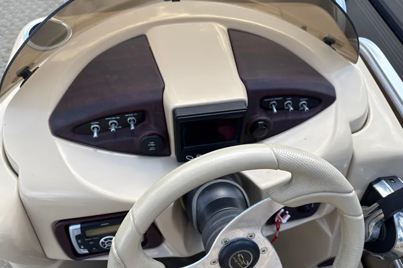 Slide: The Image of Steering console of a 2015 South Bay 522CR boat with control switches. - 10