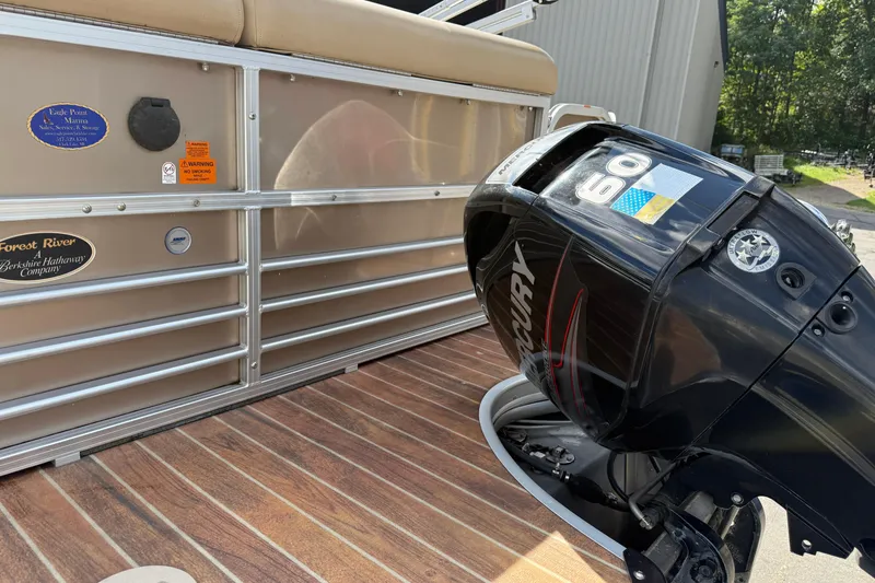 Slide: The Image of 2015 South Bay 522CR pontoon boat with Mercury 60 outboard motor, docked at marina. - 3