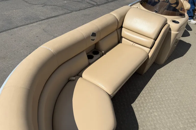 Slide: The Image of 2015 South Bay 522CR boat interior with beige seating and cup holders. - 4