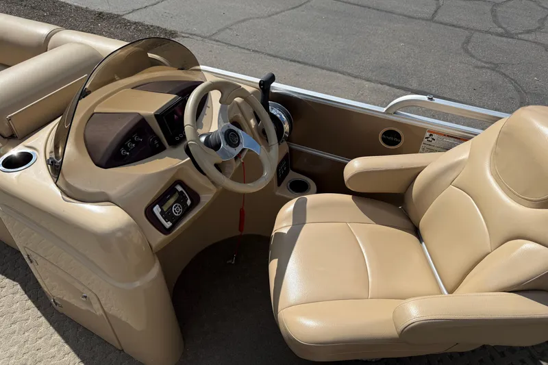 Slide: The Image of 2015 South Bay 522CR boat interior with tan leather seating and steering console. - 5