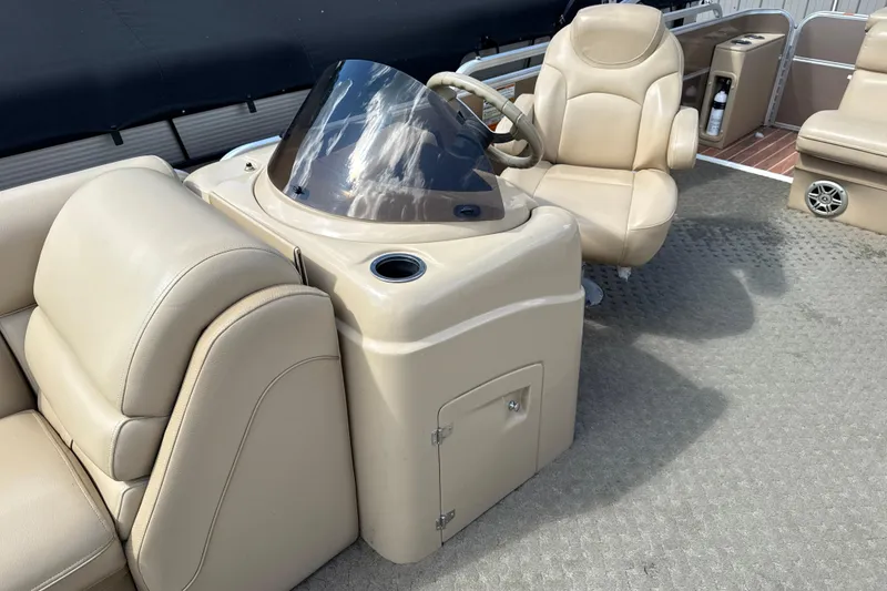 Slide: The Image of 2015 South Bay 522CR boat interior with beige seating and steering console. - 8