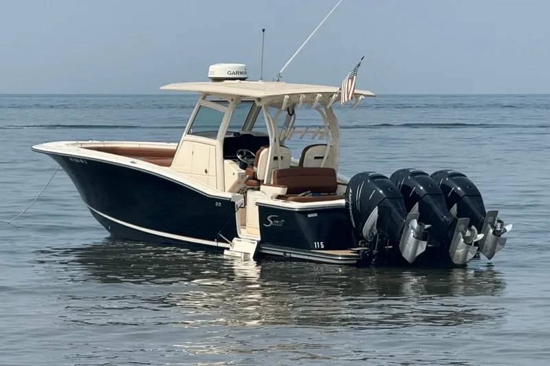The Image of 2017 Scout 350 LXF boat with four outboard engines on calm water. - 0