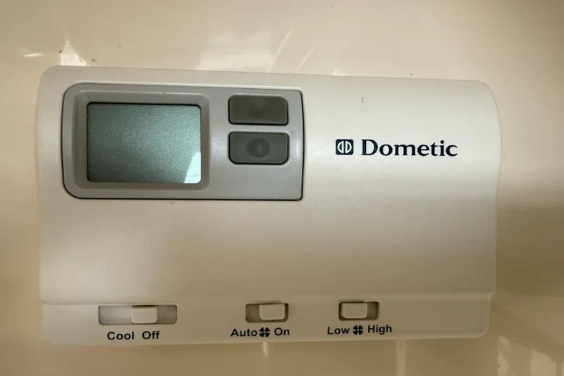 Slide: The Image of Dometic thermostat control panel with buttons for cooling and fan settings. - 10
