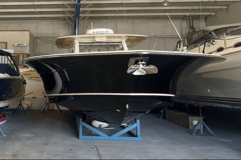 Slide: The Image of 2017 Scout 350 LXF boat in storage, front view, indoors. - 4