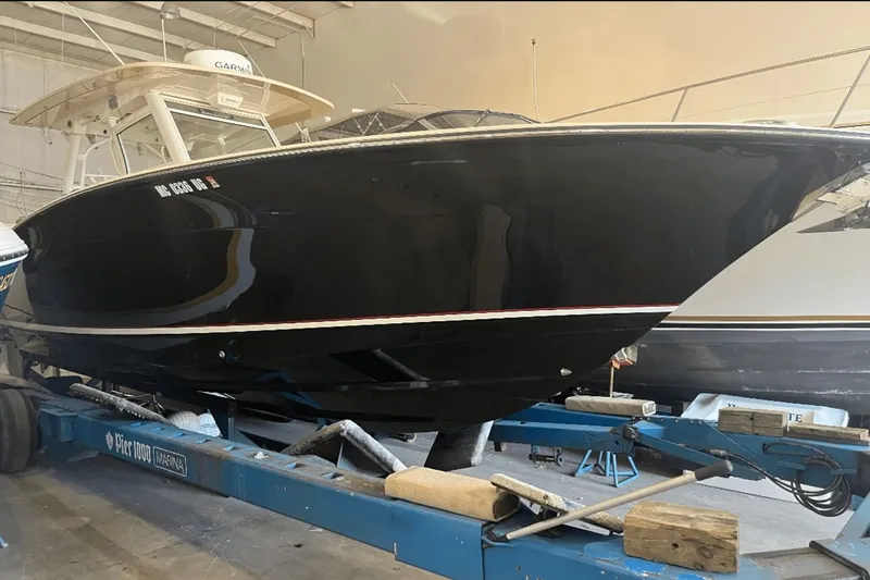 Slide: The Image of 2017 Scout 350 LXF boat on trailer in indoor storage facility. - 5
