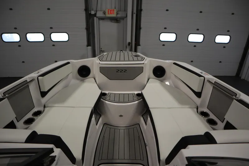 Slide: The Image of 2026 Yamaha Boats 222SD interior with sleek seating and modern design in a showroom. - 10