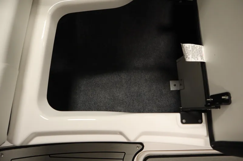 Slide: The Image of Storage compartment in 2026 Yamaha Boats 222SD, featuring a clean, carpeted interior. - 15