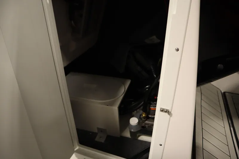 Slide: The Image of Open storage compartment in 2026 Yamaha Boats 222SD, showcasing interior details. - 17