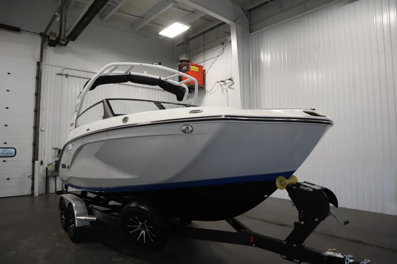 Slide: The Image of 2026 Yamaha Boats 222SD in a showroom, showcasing sleek design and modern features. - 2