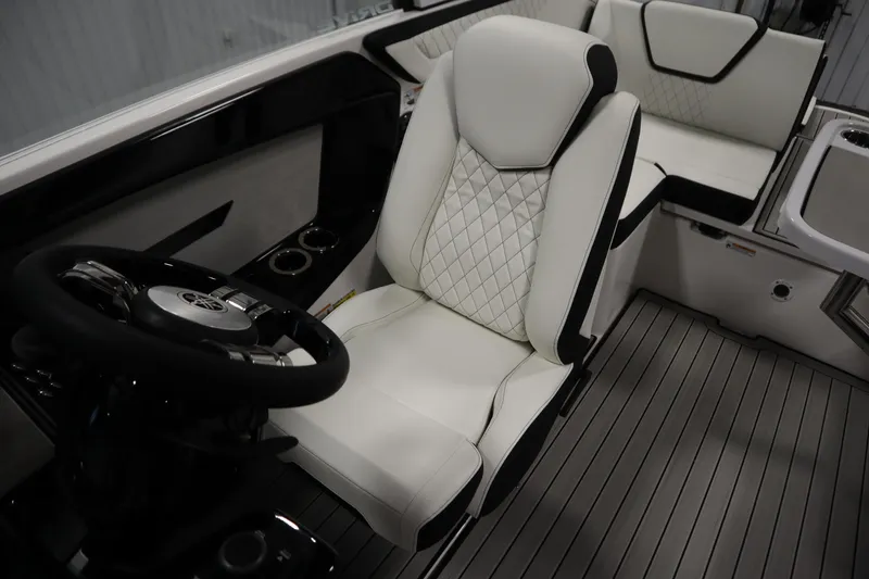 Slide: The Image of 2026 Yamaha Boats 222SD interior with luxurious white seating and sleek steering wheel design. - 26