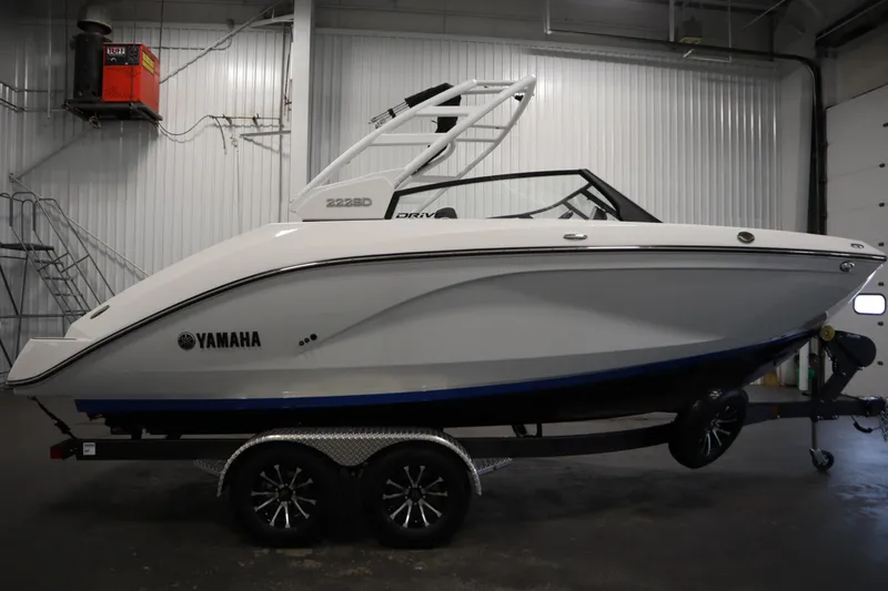 Slide: The Image of 2026 Yamaha Boats 222SD in a showroom, side view on a trailer. - 3