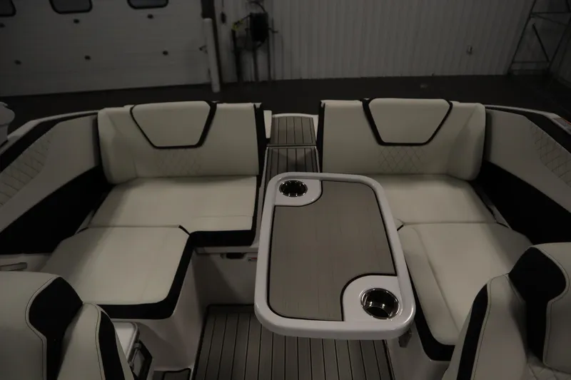 Slide: The Image of 2026 Yamaha Boats 222SD interior with white seating and central table featuring cup holders. - 34
