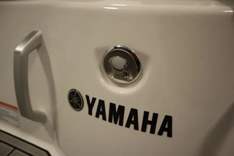 Slide: The Image of 2026 Yamaha Boats 222SD, close-up of logo and handle on white surface. - 43