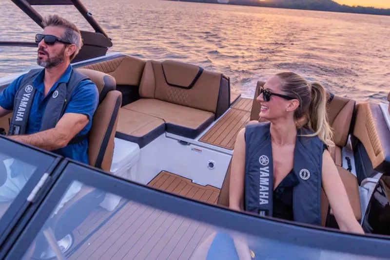 Slide: The Image of Couple enjoying a sunset ride on a 2026 Yamaha Boats 222SD. - 50