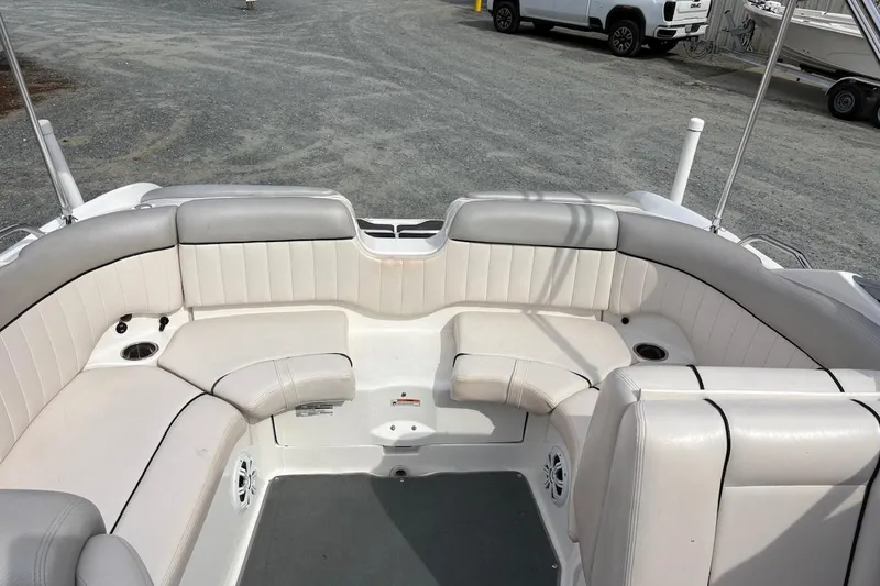 Slide: The Image of 2009 Yamaha Boats SX230 HO interior with white cushioned seating and cup holders. - 11