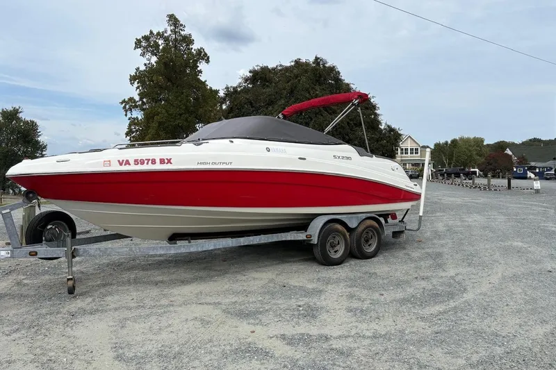 Slide: The Image of 2009 Yamaha Boats SX230 HO on trailer, red and white design, parked outdoors. - 13