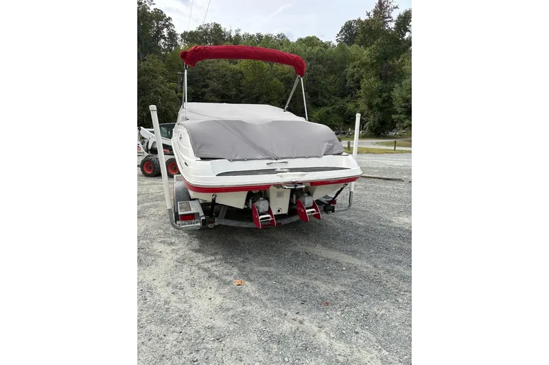 Slide: The Image of 2009 Yamaha Boats SX230 HO with cover, parked on gravel, rear view. - 3