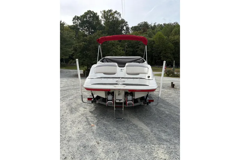 Slide: The Image of 2009 Yamaha Boats SX230 HO with red canopy, rear view on gravel. - 5