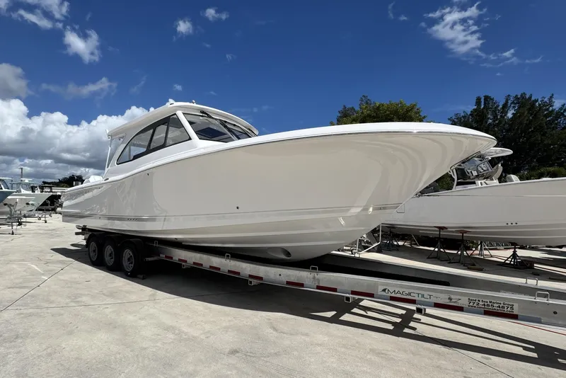 The Image of 2026 Southport 33 DC boat on trailer under clear blue sky. - 0