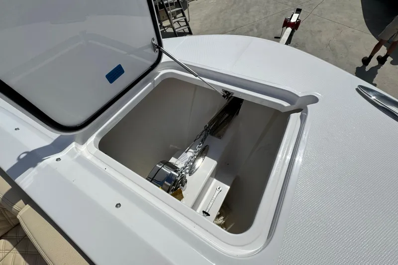 Slide: The Image of Open anchor compartment on 2026 Southport 33 DC boat, showcasing storage and chain mechanism. - 10