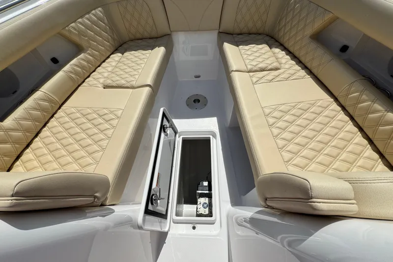 Slide: The Image of Luxurious seating on 2026 Southport 33 DC boat with diamond-stitched upholstery and storage compartment. - 12