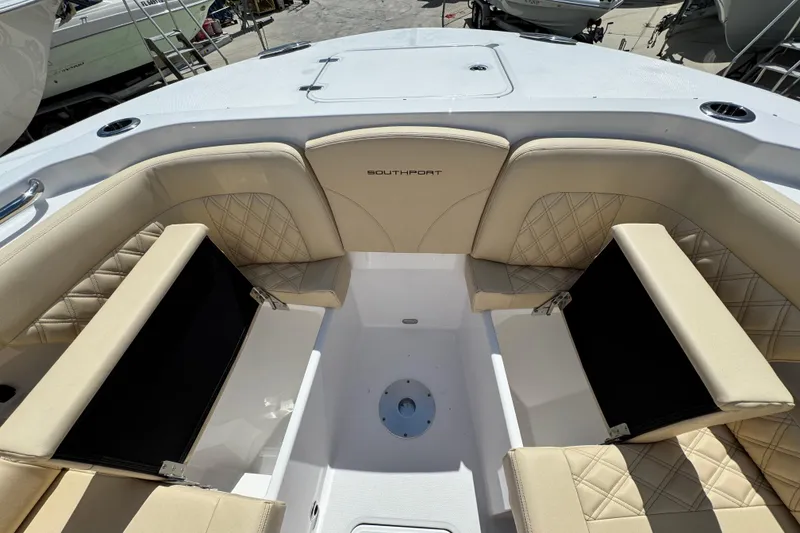 Slide: The Image of 2026 Southport 33 DC boat interior with beige seating and diamond stitching. - 13