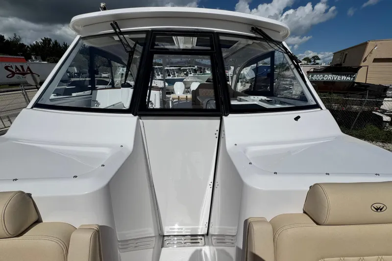 Slide: The Image of 2026 Southport 33 DC boat with sleek design and spacious seating under a cloudy sky. - 14