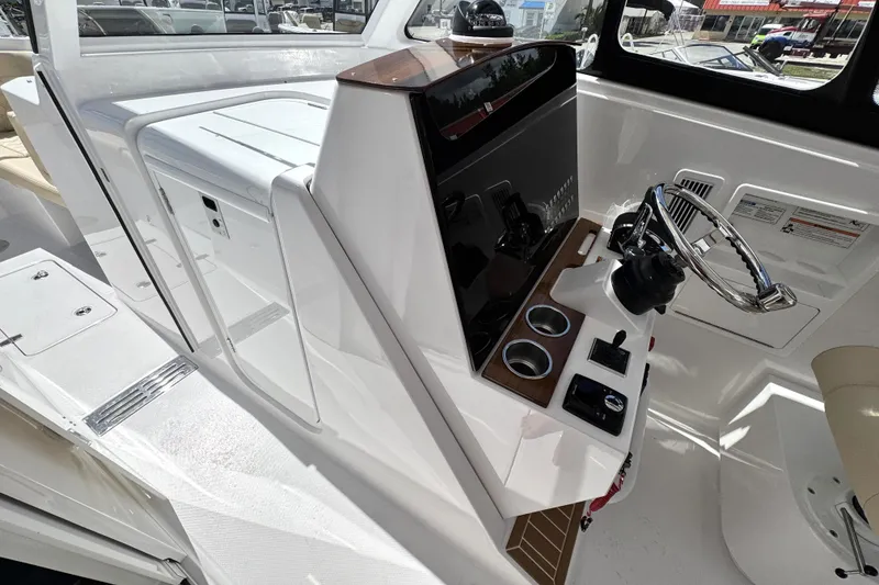 Slide: The Image of 2026 Southport 33 DC boat helm with modern controls and sleek design. - 15