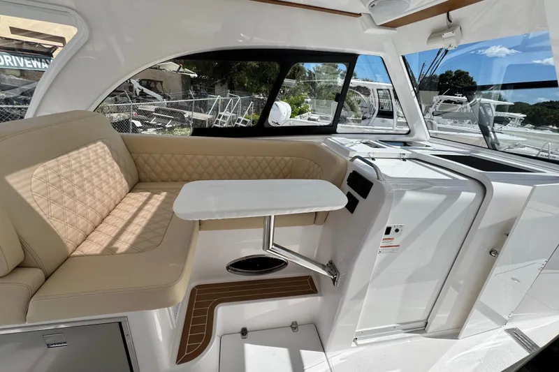 Slide: The Image of Luxurious interior of 2026 Southport 33 DC boat with beige seating and table. - 19