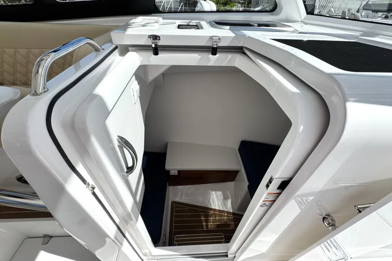 Slide: The Image of 2026 Southport 33 DC cabin interior with open door, showcasing seating and storage. - 20